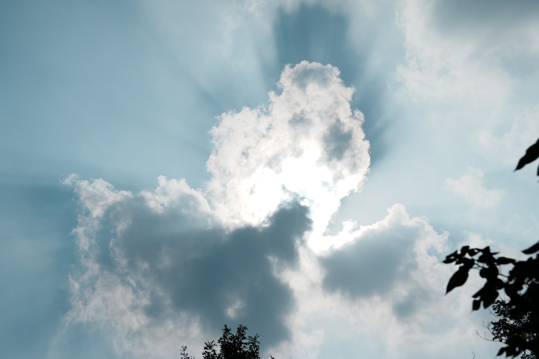 Sunbeams breaking through dramatic clouds in the sky.