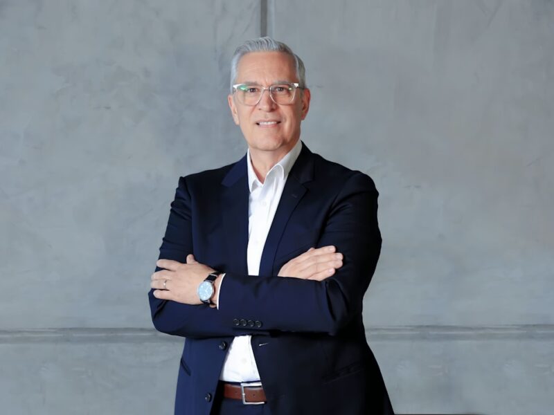 a man in a suit standing with his arms crossed
