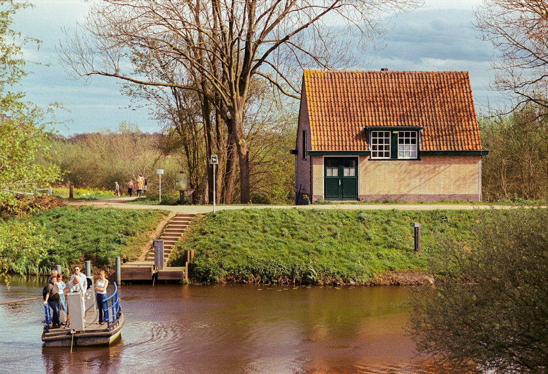 a group of people standing on a boat in a body of water
