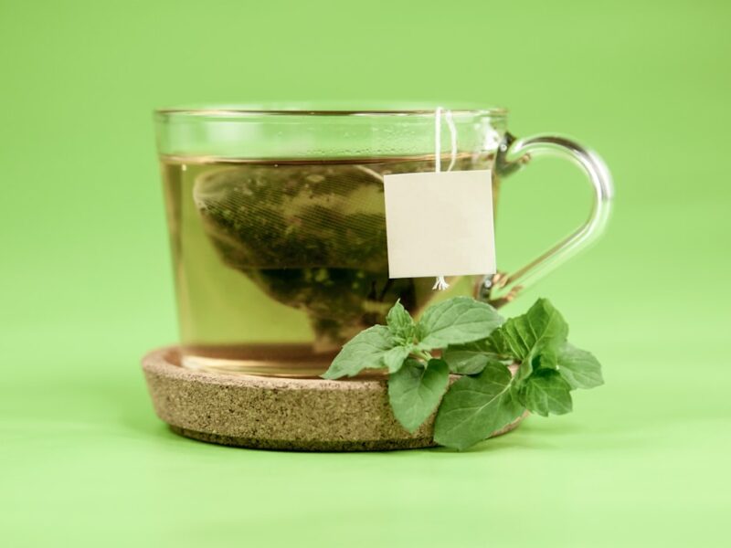 clear glass mug with green leaves