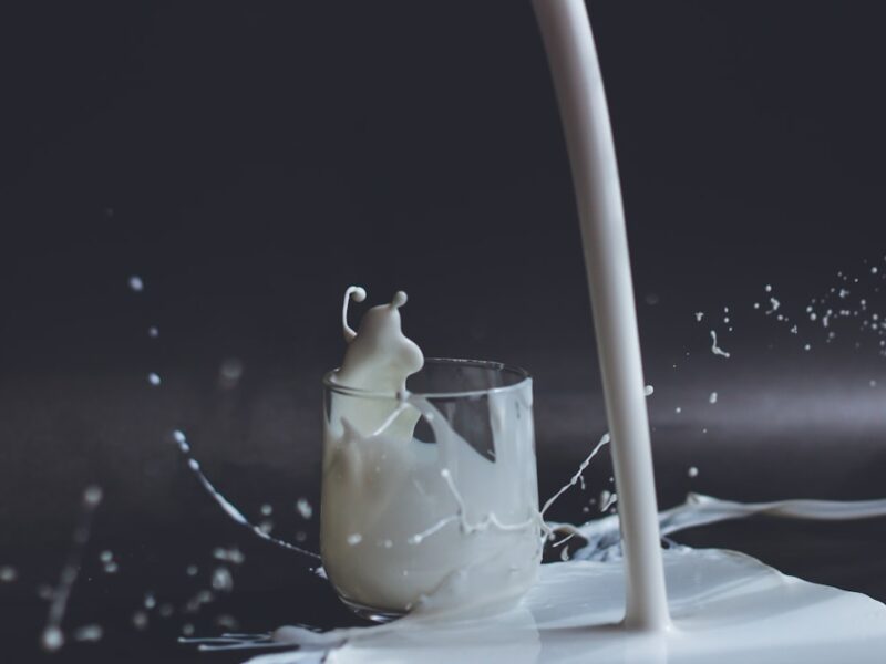 white candle in clear glass holder
