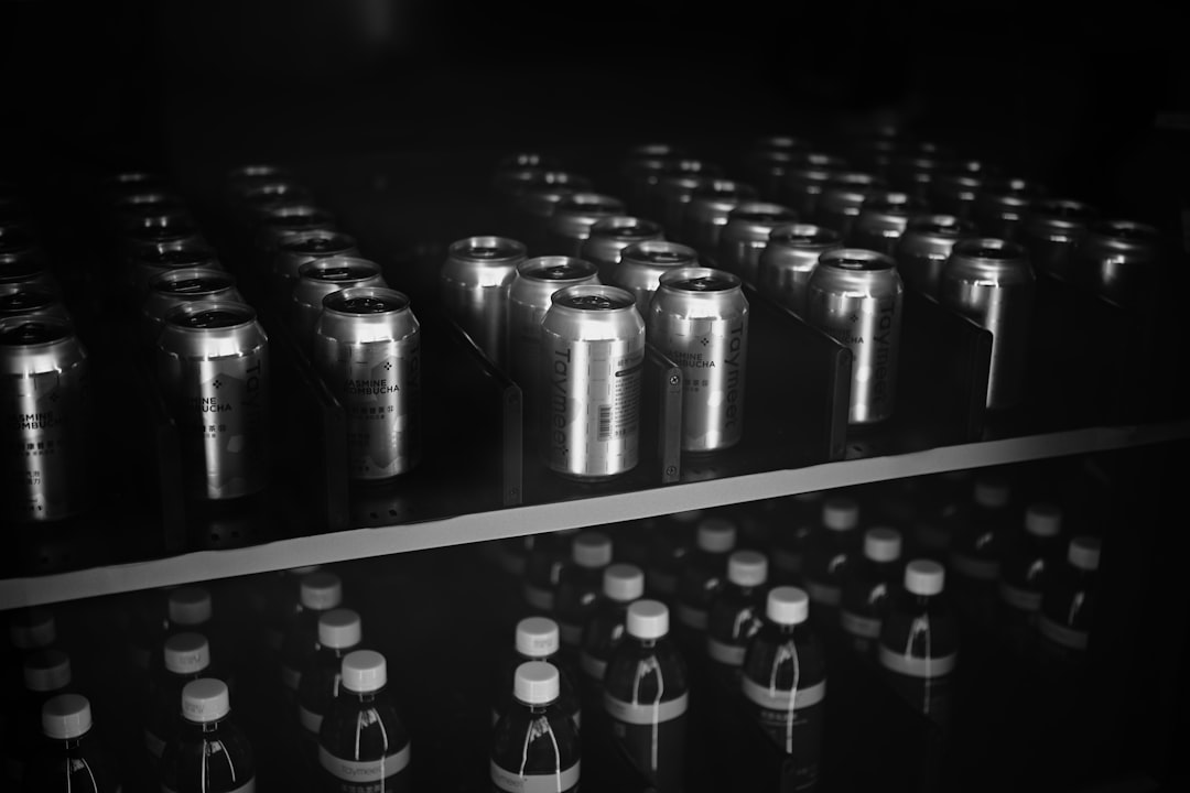 Rows of aluminum cans and glass bottles in darkness