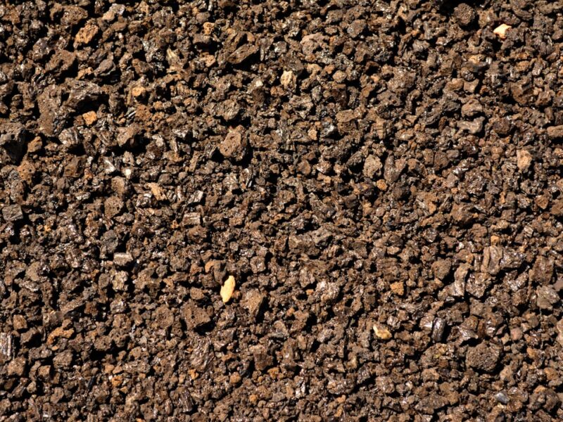 a close up of a dirt surface with small rocks