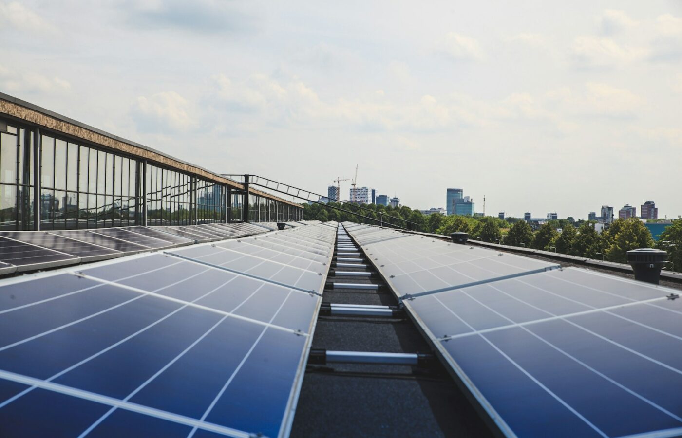 Zonnepanelen op het dak van een bedrijfspand met daarachter een loods